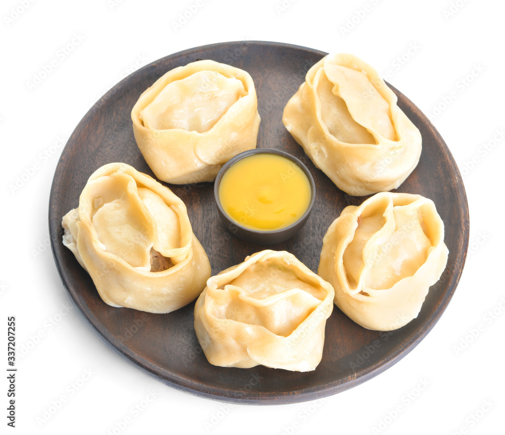 Plate with oriental dumplings and sauce on white background