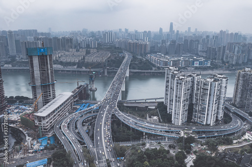 Aerial drone shot of flyover with heavy traffic in foggy gloomy weather in Chongqing, China photo