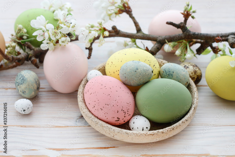 Colorful Easter eggs and blooming apple tree branch Colorful Easter eggs and blooming apple tree branch