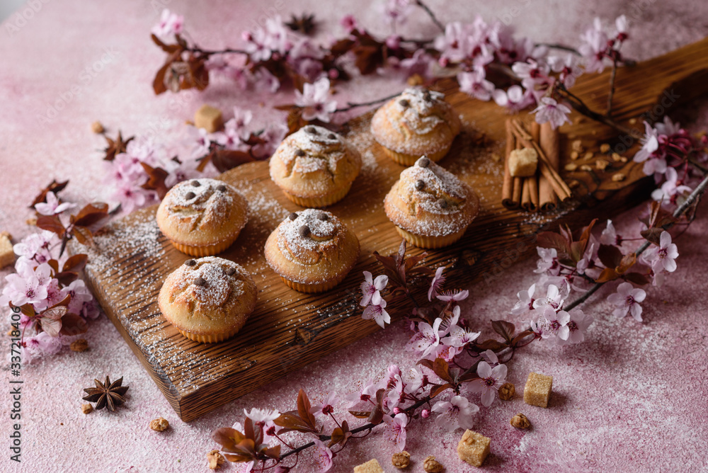 Fototapeta premium Fresh baked cupcakes of rice flour with banana and vanilla with a mug of hot chocolate