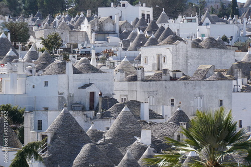 Landscape view of white round houses with specific architecture and stone roof from unesco world heritage Trulli of Alberobello in Italy