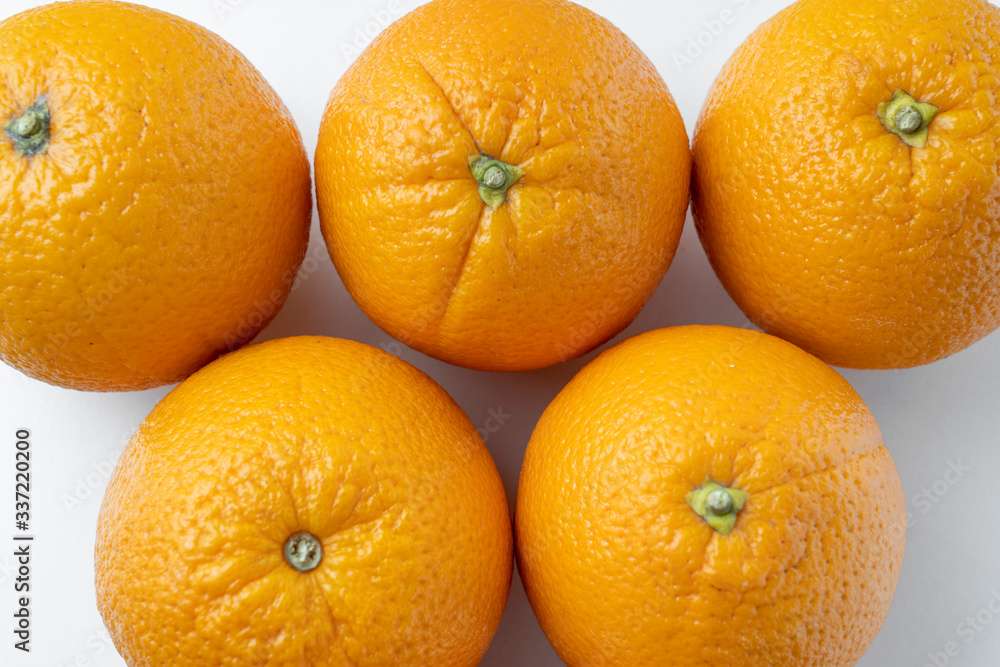 fresh oranges on a white background close up fresh oranges on a white background close up