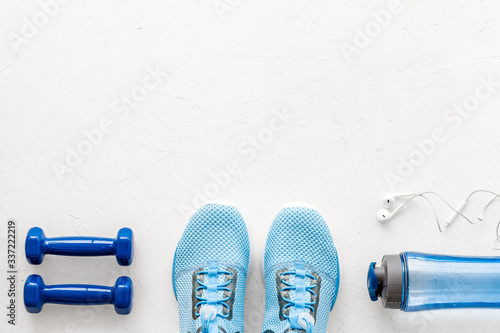 Athletics set. Dumbbells and sneakers on white background top-down copy space
