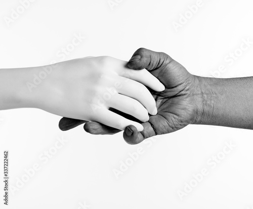 Handshake of black and white hands on an isolated background.