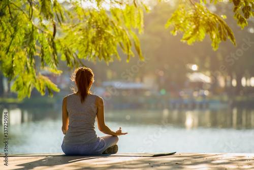 Wallpaper Mural Young woman doing yoga in morning park Torontodigital.ca