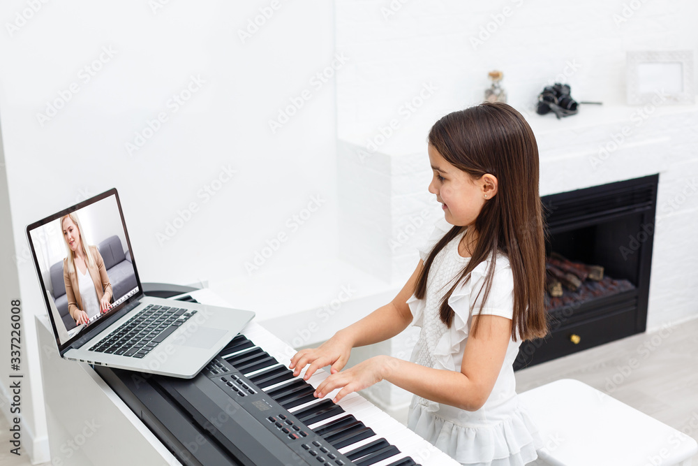 Scene of piano lessons online training or E-class learning while  Coronavirus spread out or covid-19 crisis situation, vlog or teacher make online  piano lesson to teach students pupils learn from home. Stock