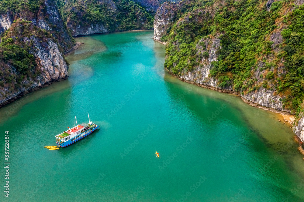 Aerial view of Sang cave and Kayaking area, Halong Bay, Vietnam, Southeast Asia. UNESCO World Heritage Site. Junk boat cruise to Ha Long Bay. Popular landmark, famous destination of Vietnam