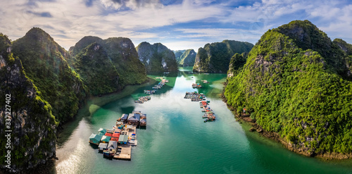 Aerial view of Cua Van floating fishing village and rock island, Halong Bay, Vietnam, Southeast Asia. UNESCO World Heritage Site. Junk boat cruise to Ha Long Bay. Famous destination of Vietnam