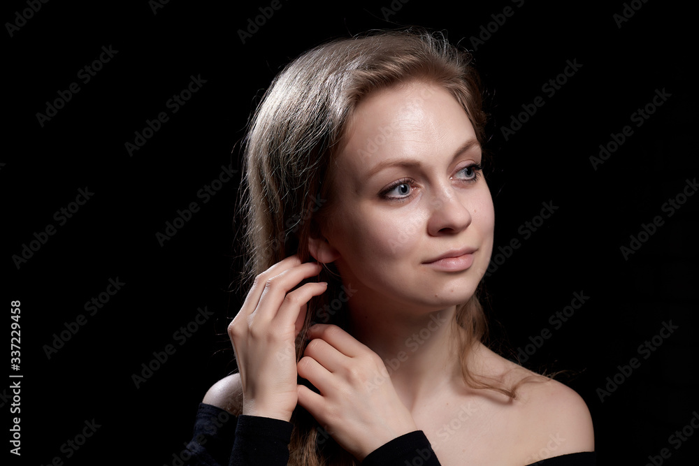 Beautiful gentle girl with long blonde hair on dark background. Romantic portrait in Renaissance style Beautiful gentle girl with long blonde hair on dark background. Romantic portrait in Renaissance style