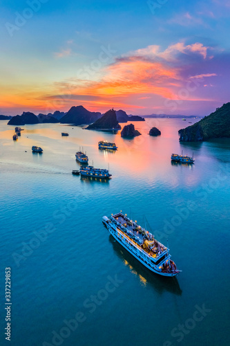 Aerial view floating fishing village and rock island, Halong Bay, Vietnam, Southeast Asia. UNESCO World Heritage Site. Junk boat cruise to Ha Long Bay. Popular landmark, famous destination of Vietnam