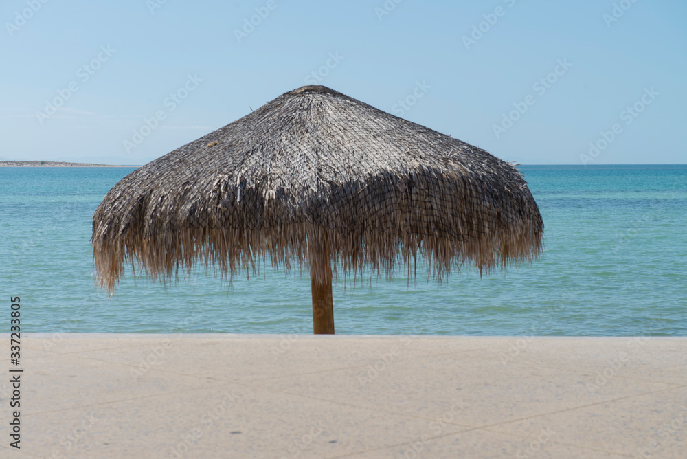 Palapa in a sunny day in the malecon of La Paz, with the sea of cortes on the background, in the state of Baja California Sur. Mexico