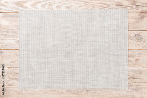 Top view of empty white tablecloth on wooden background with copy space photo