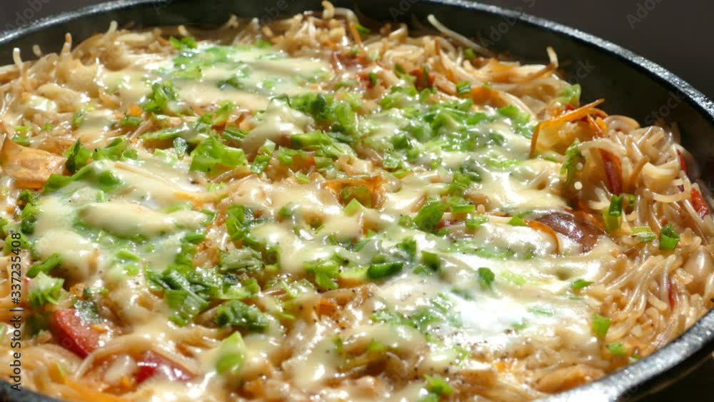 Cooking dinner in a pan. Pasta casserole. Macaroni with green onions and cheese. Cooking dinner in a pan. Pasta casserole. Macaroni with green onions and cheese.