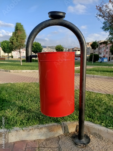 red trash can in  park © emel