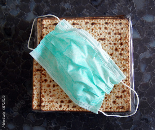 Corona Passover. Dust mask, bottle of wine and matzah - a traditional Jewish food for Passover photo