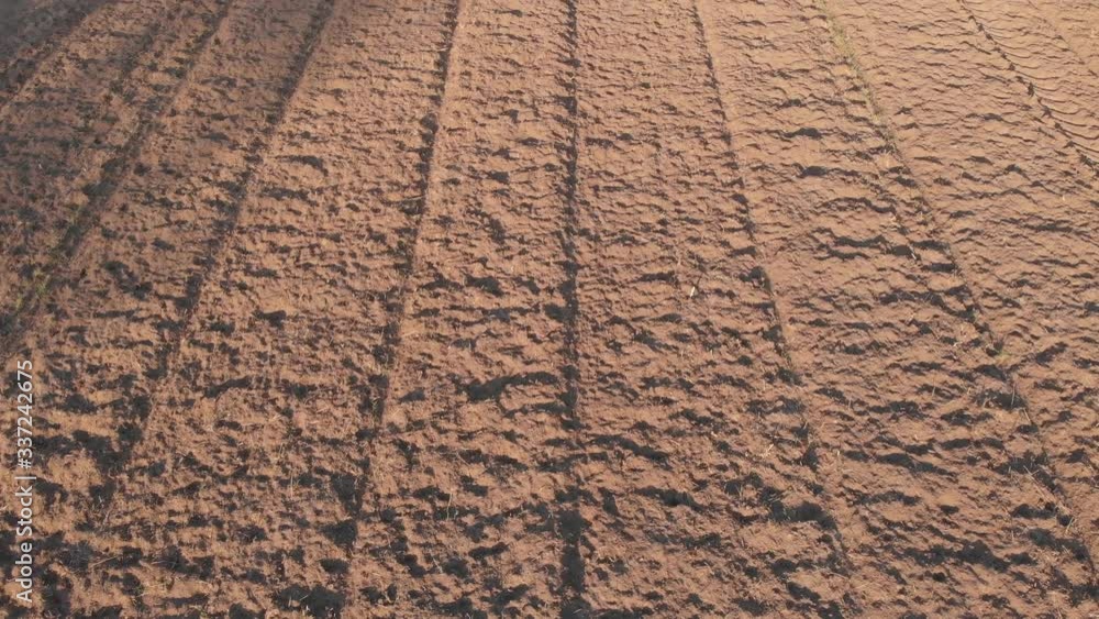 Gliding over a freshly plowed and milled agricultural field, ready to sow seeds or plant crops. Gliding over a freshly plowed and milled agricultural field, ready to sow seeds or plant crops.