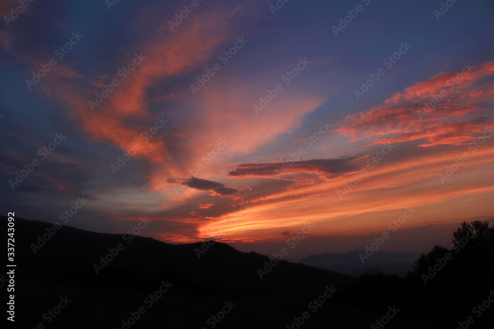 The sky with sunset colores above the dark mountains. The sky with sunset colores above the dark mountains.