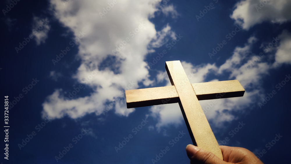 Lent Season,Holy Week and Good Friday concepts - image of wooden cross raise to the sky with hand holding it background
Lent Season,Holy Week and Good Friday concepts - image of wooden cross raise to the sky with hand holding it background