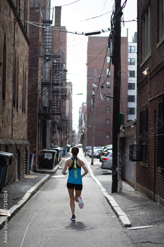 Woman Runner in the back streets of Boston city © Sacha Specker