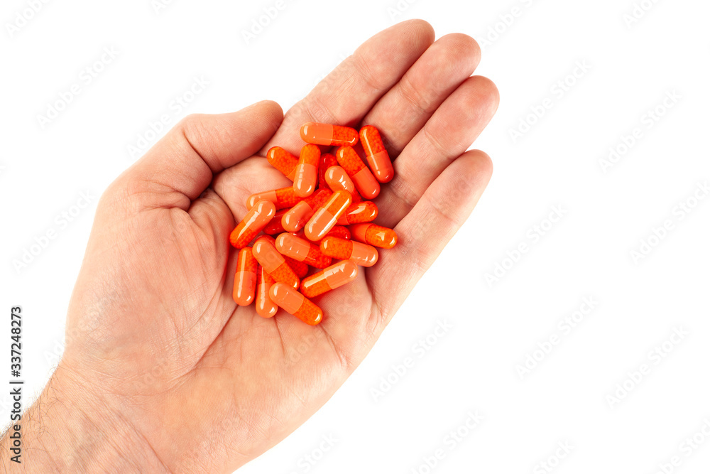 Man's hand isolated on white background with vitamin pills Man's hand isolated on white background with vitamin pills