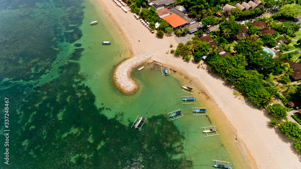 Aerial view of traditional balinese fishing boats in lagoon at anchor.