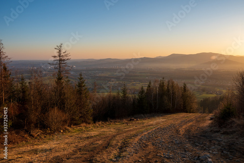 view of valley from hill at sunrise  houses and fields in countryside at sunrise  czech Beskydy Trinec