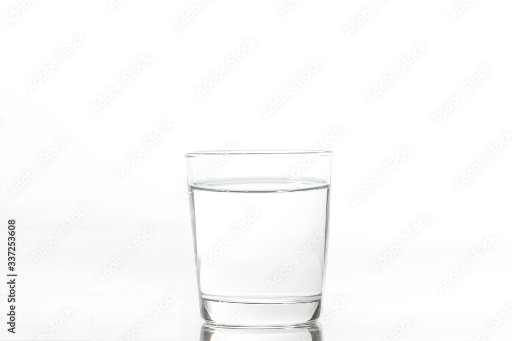 Glass with water and ice on a white background. Glass of mineral water and ice on white background. Glass with water and ice on a white background. Glass of mineral water and ice on white background.