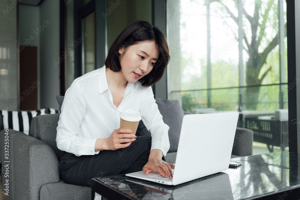 An Asian business woman with short hair is working An Asian business woman with short hair is working