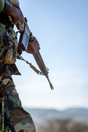 soldier in camouflage with a rifle