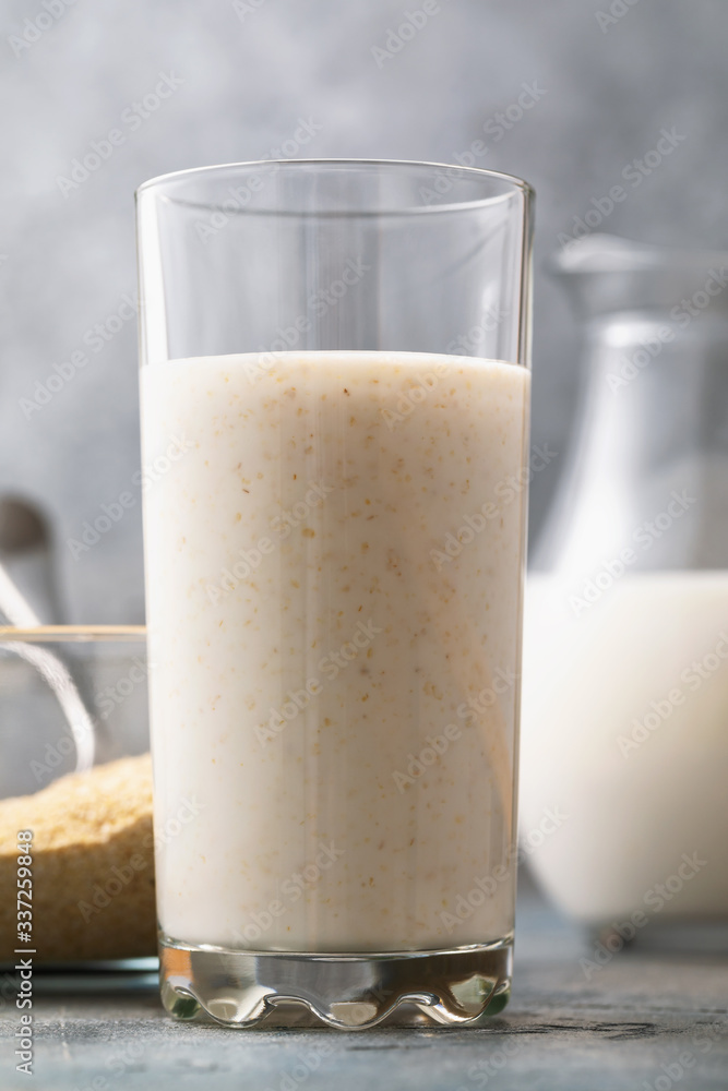 A glass of kefir with oat bran close-up. Concept on the topic of a useful beverage for digestion A glass of kefir with oat bran close-up. Concept on the topic of a useful beverage for digestion