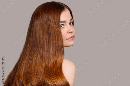 Portrait of a woman with bright wavy red hair. Copycpase