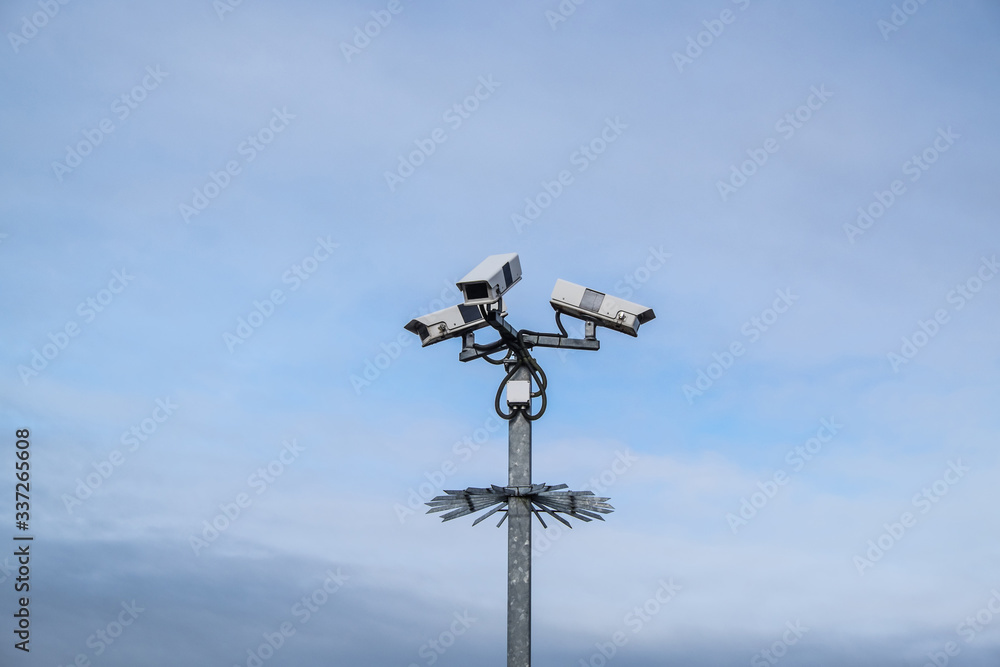 Security surveillance cameras on a post with spikes in England, UK