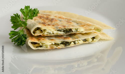 qutab with spinach and cheese cut open decorated with parsley