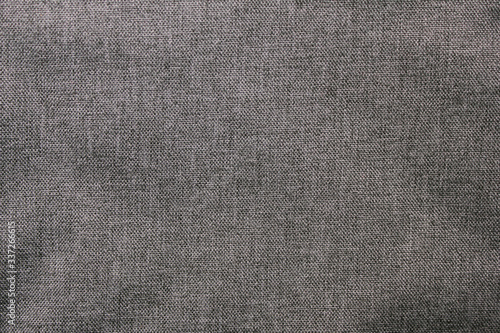 Dark gray fabric texture, metallic color background cloth. Monochrome dark grey texture, wavy empty clothing material surface, blank wrinkled fabric canvas