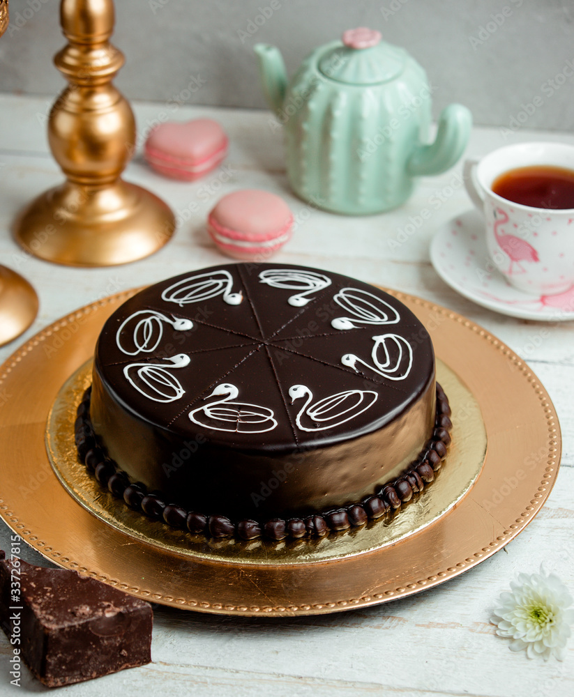 chocolate cake on a tray and a cup of fragrant tea