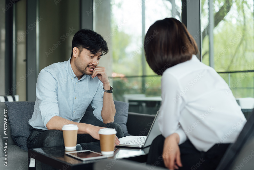 Two young Asian business men and women are working Two young Asian business men and women are working
