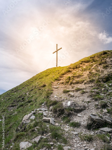 Orange light around a cross on top of a mountain - a sign of God.
