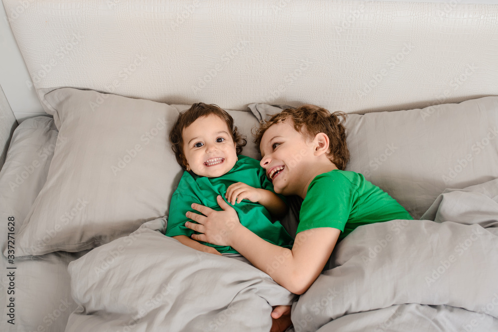 Happy little kids brother and sister in green t-shirts Happy little kids brother and sister in green t-shirts