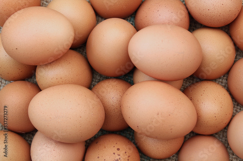 Lots of fresh chicken eggs on burlap sack,top view