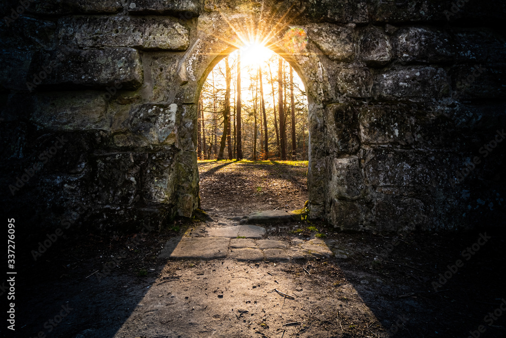 ancient archway with sun in the center