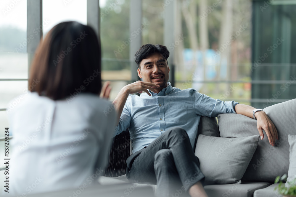 Two young Asian business men and women are working Two young Asian business men and women are working