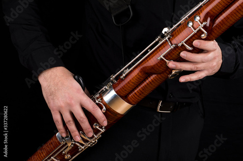 Fotografie Wooden bassoon isolated on a black background