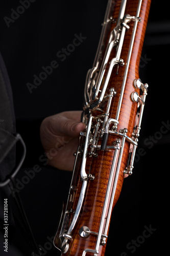 Wooden bassoon isolated on a black background. Musical instruments. Musician playing the instrument.