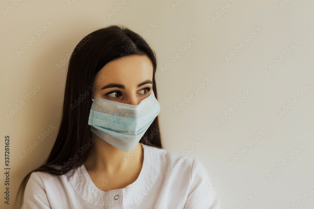 Close up studio portrait of woman wearing face medical mask, looking away, isolated on white background. Covid-19, coronavirus pandemic. Copy space for advertising. Close up studio portrait of woman wearing face medical mask, looking away, isolated on white background. Covid-19, coronavirus pandemic. Copy space for advertising.