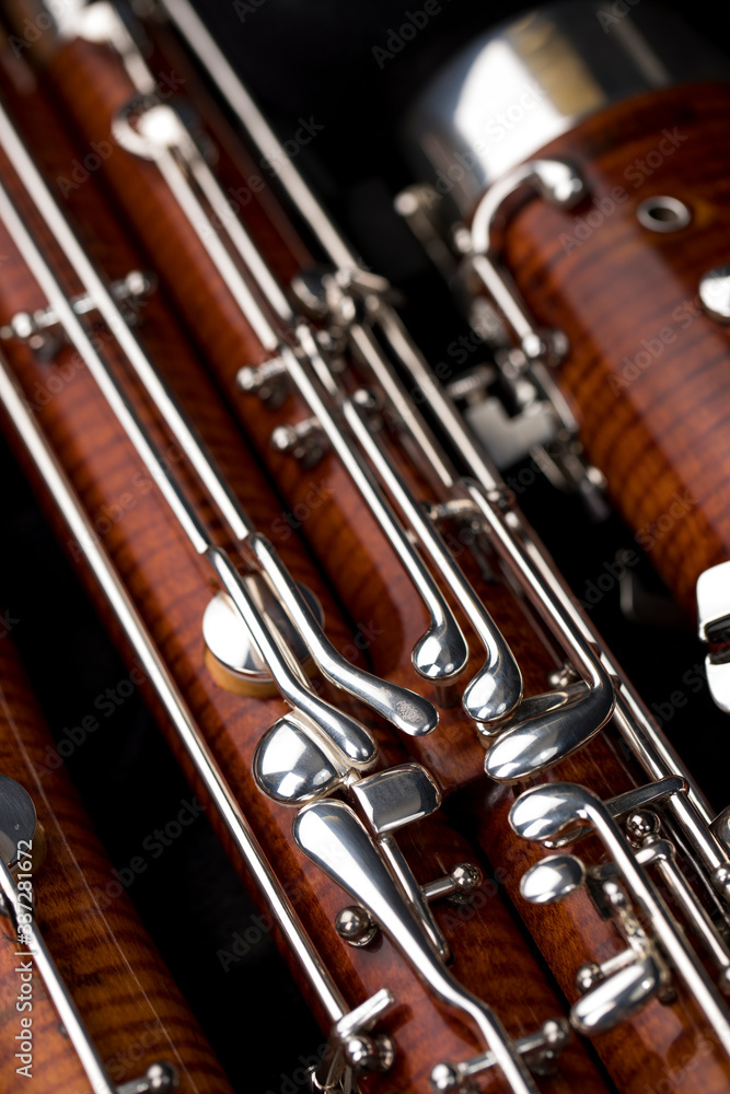 Fototapeta premium Wooden bassoon isolated on a black background. Music instruments.
