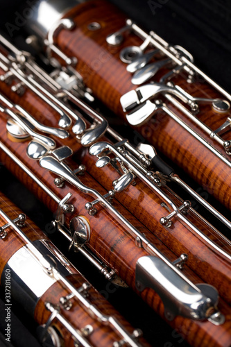Wooden bassoon isolated on a black background. Music instruments.