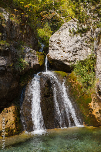 Enipeas waterfall with small lake surrounded by trees