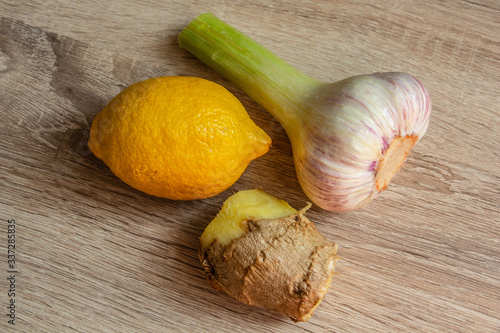 garlic, ginger and lemon on a wooden background closeup