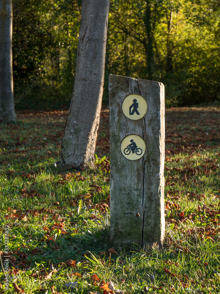 Sign post for pedestrians and cyclists. Autumnal impression at Olarizu Park. Vitoria-Gasteiz, Basque Country, Spain Sign post for pedestrians and cyclists. Autumnal impression at Olarizu Park. Vitoria-Gasteiz, Basque Country, Spain