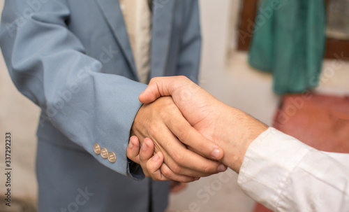 two businessmen shaking hands when closing a deal